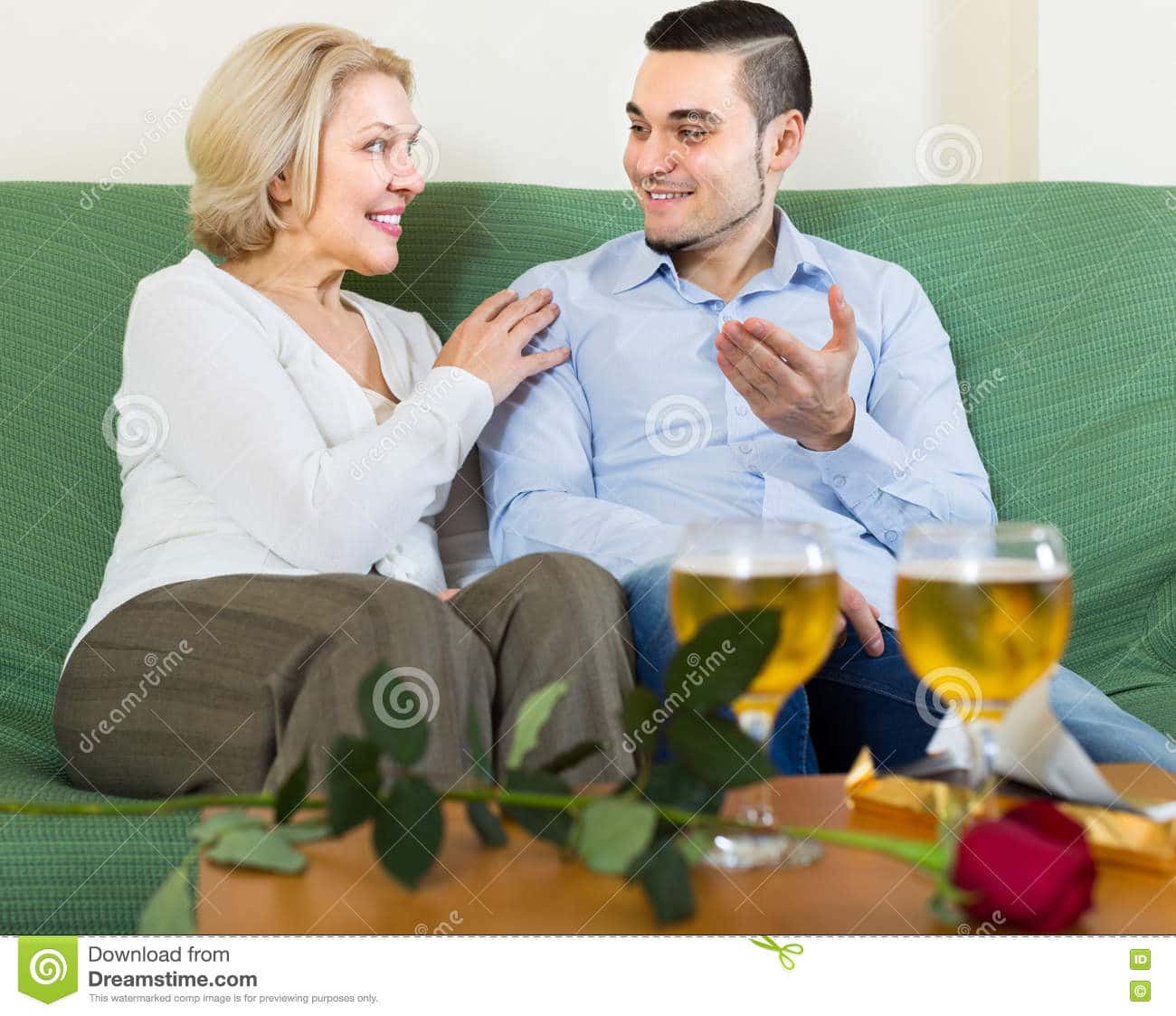 Mature Woman with Young Guy Indoors Stock Photo