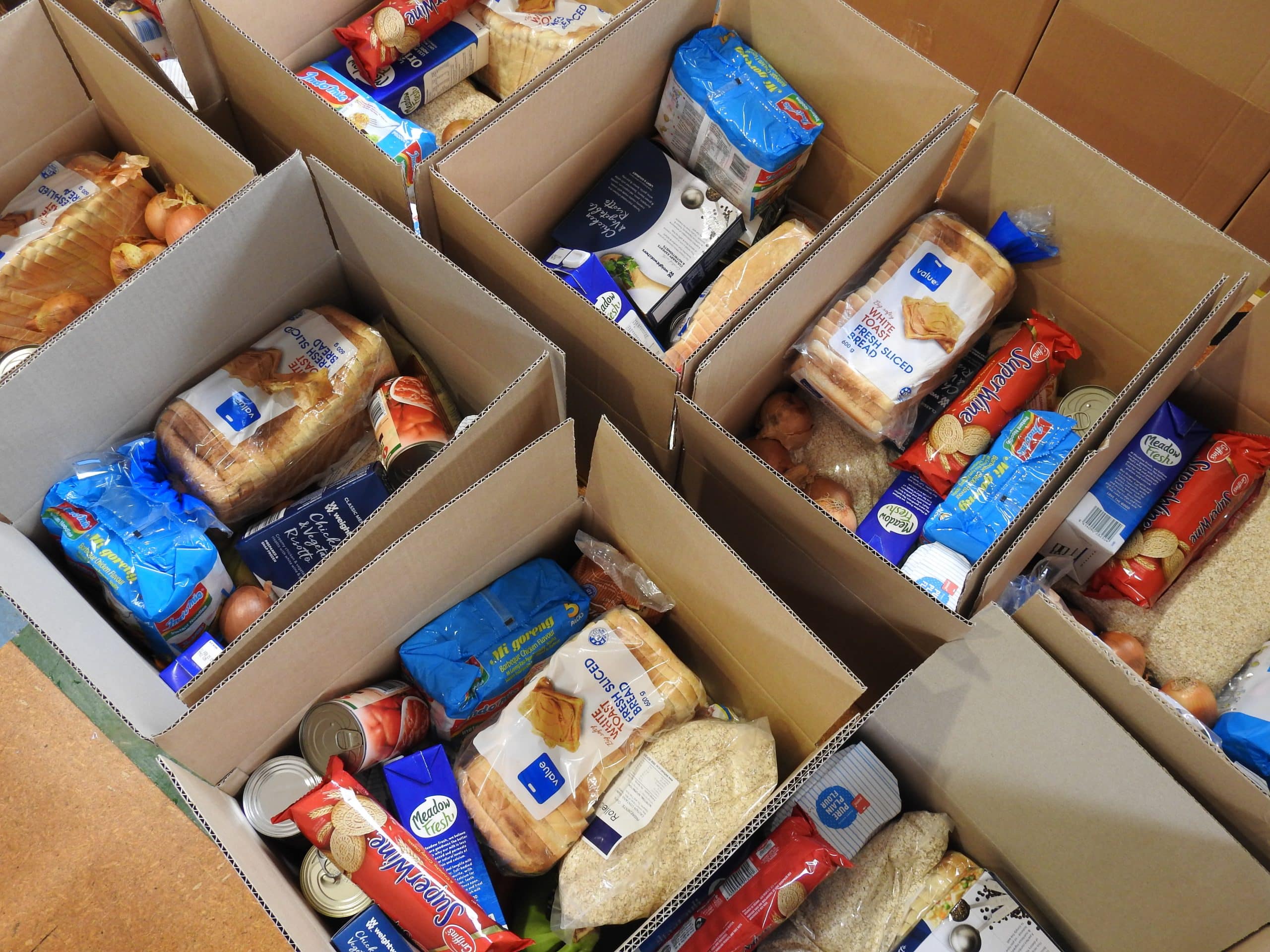 Volunteers wrap up three hundred food parcels for elderly and families ...