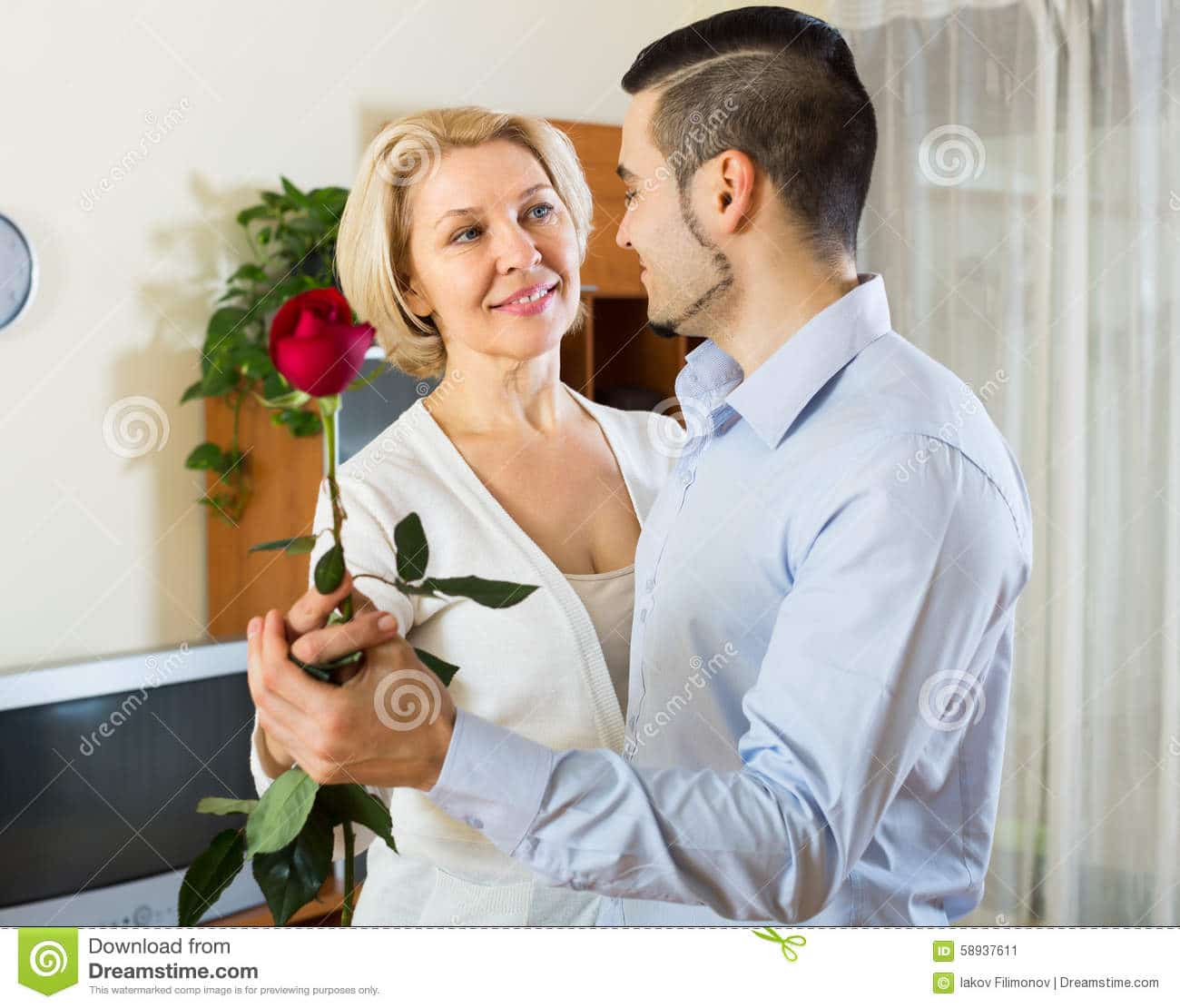 Young Man And Aged Woman Dancing Indoor Stock Image